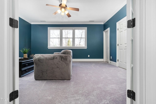 sitting room with a ceiling fan, visible vents, carpet floors, and ornamental molding