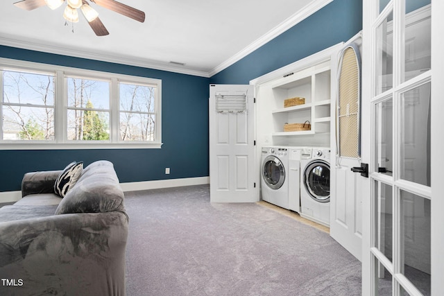 washroom featuring crown molding, carpet, washer and clothes dryer, laundry area, and a ceiling fan