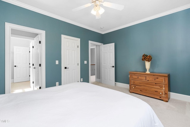 carpeted bedroom featuring crown molding, baseboards, and ceiling fan