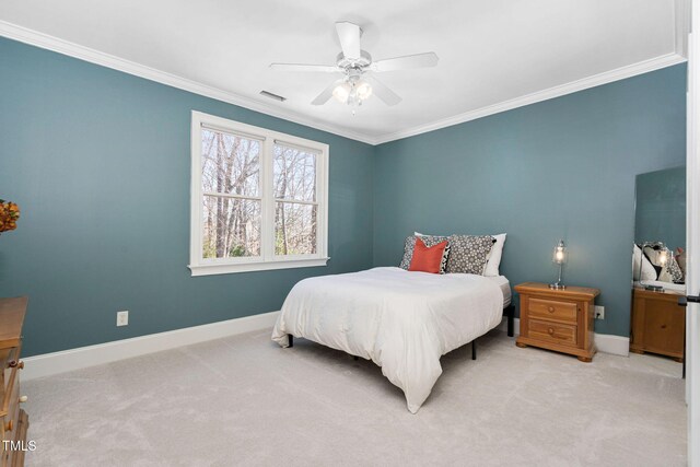 carpeted bedroom featuring crown molding, visible vents, baseboards, and ceiling fan