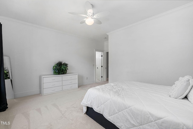 carpeted bedroom with a ceiling fan, baseboards, and ornamental molding