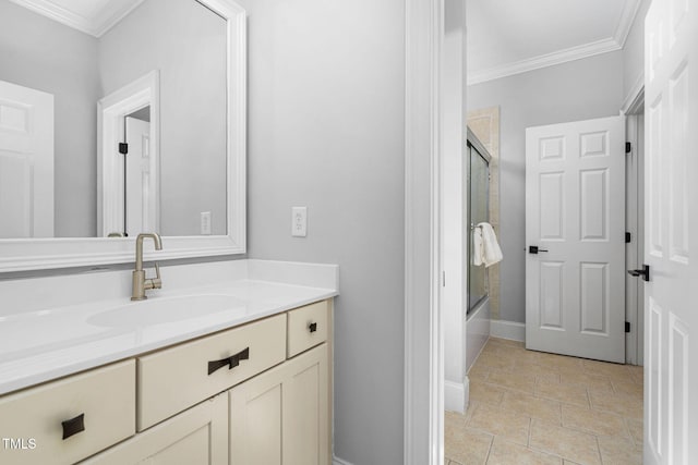 full bath with vanity, crown molding, baseboards, and shower / bath combination with glass door