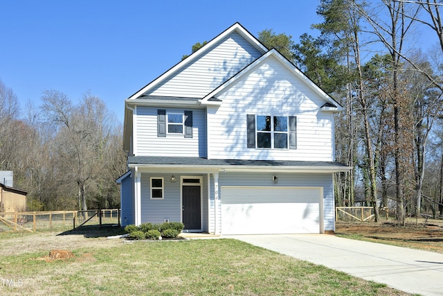 traditional home with a garage, concrete driveway, a front lawn, and fence