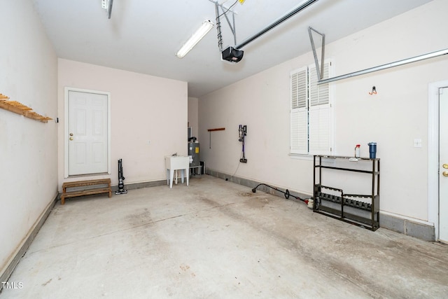 garage featuring a garage door opener, water heater, and baseboards