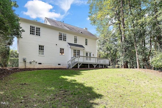 back of house featuring crawl space, a lawn, a chimney, and a deck