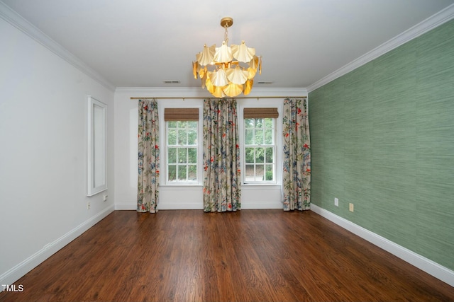 empty room featuring visible vents, crown molding, wood finished floors, and baseboards