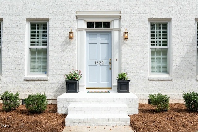 entrance to property featuring stucco siding