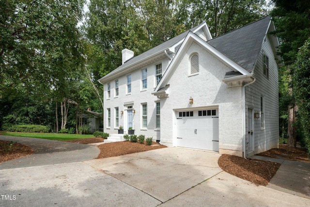 view of front of property with driveway and a chimney