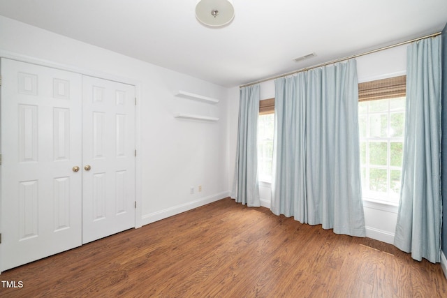 1222 Dixie Trl, Raleigh, NC 27607 - unfurnished bedroom featuring wood finished floors