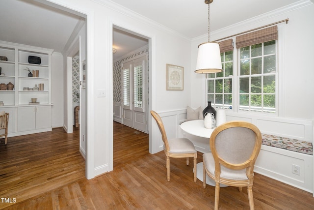 1222 Dixie Trl, Raleigh, NC 27607 - dining space with a decorative wall, wood finished floors, wainscoting, and ornamental molding