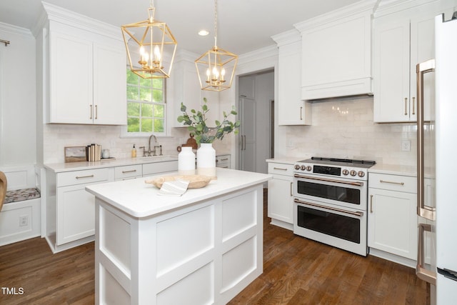 1222 Dixie Trl, Raleigh, NC 27607 - kitchen with double oven range, a chandelier, light countertops, white cabinetry, and recessed lighting