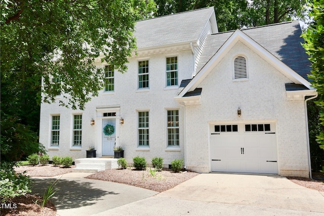 1222 Dixie Trl, Raleigh, NC 27607 - colonial house featuring concrete driveway, roof with shingles, and an attached garage