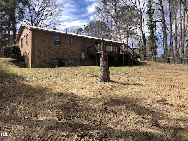 back of property featuring cooling unit, fence, brick siding, and a wooden deck