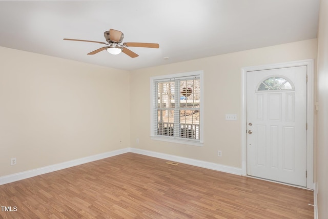 entrance foyer with ceiling fan, baseboards, and light wood-style flooring