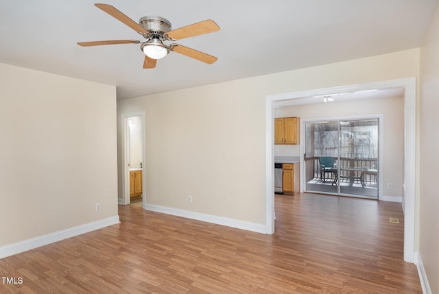 empty room featuring light wood-style flooring, baseboards, and ceiling fan