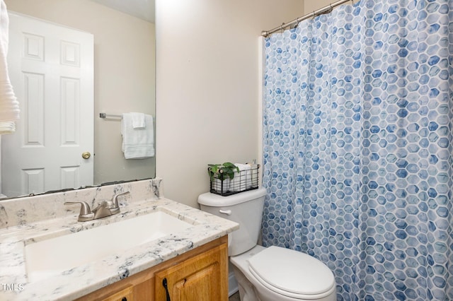 bathroom with a shower with shower curtain, toilet, and vanity