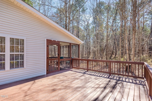 wooden deck with a sunroom