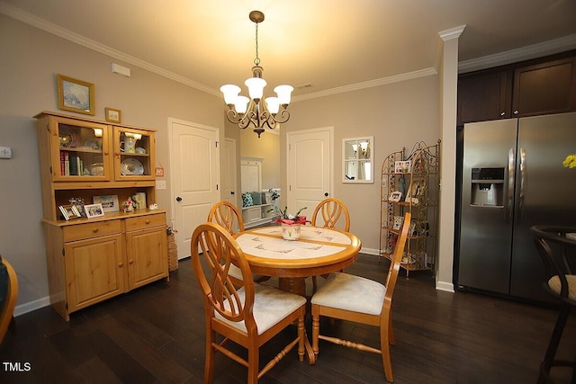 dining area with dark wood finished floors, a notable chandelier, crown molding, and baseboards