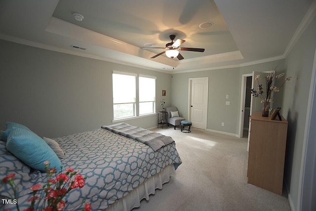 bedroom with visible vents, baseboards, light colored carpet, ornamental molding, and a raised ceiling