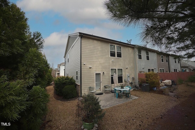 back of property featuring a patio, central AC, and fence