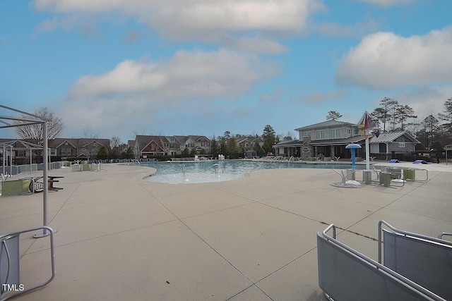 pool featuring a residential view and a patio area