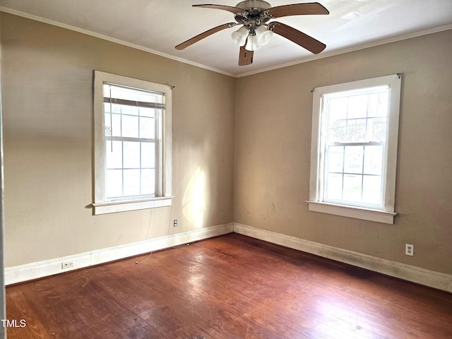 unfurnished room featuring a wealth of natural light, crown molding, and wood finished floors