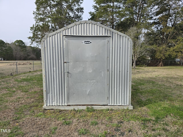 view of shed featuring fence