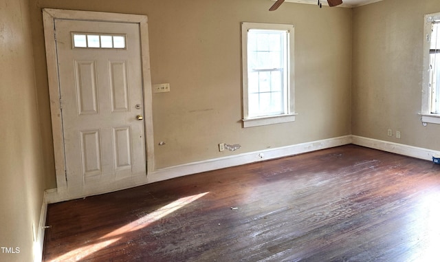 foyer featuring baseboards, ceiling fan, and wood finished floors