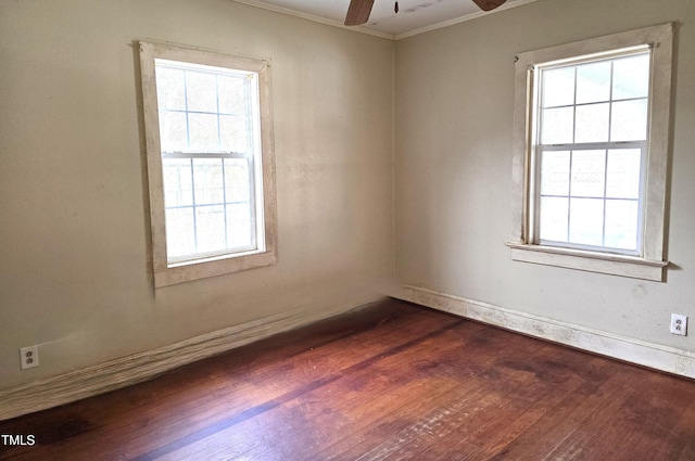 unfurnished room with crown molding, ceiling fan, and dark wood-style flooring