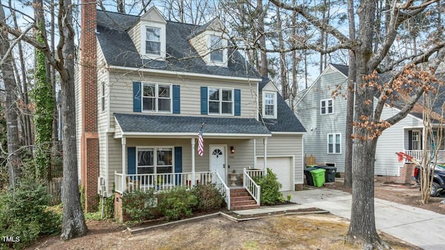 view of front of property with roof with shingles, a porch, a chimney, concrete driveway, and a garage