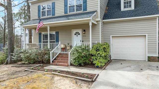 view of front of home with concrete driveway, a garage, covered porch, and roof with shingles