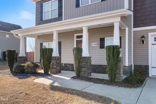 view of exterior entry featuring a porch