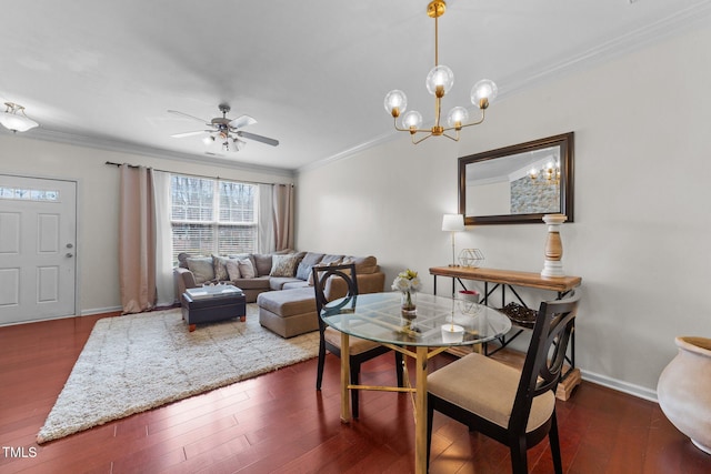 dining area with baseboards, wood finished floors, ornamental molding, and ceiling fan with notable chandelier