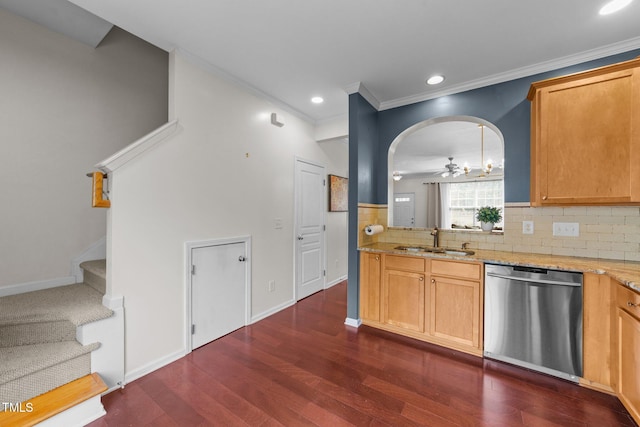 kitchen with light stone countertops, a sink, dark wood-type flooring, dishwasher, and backsplash