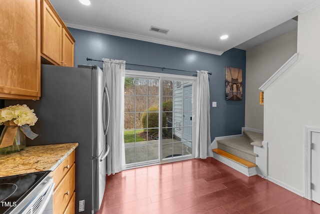 kitchen with visible vents, baseboards, dark wood finished floors, and crown molding