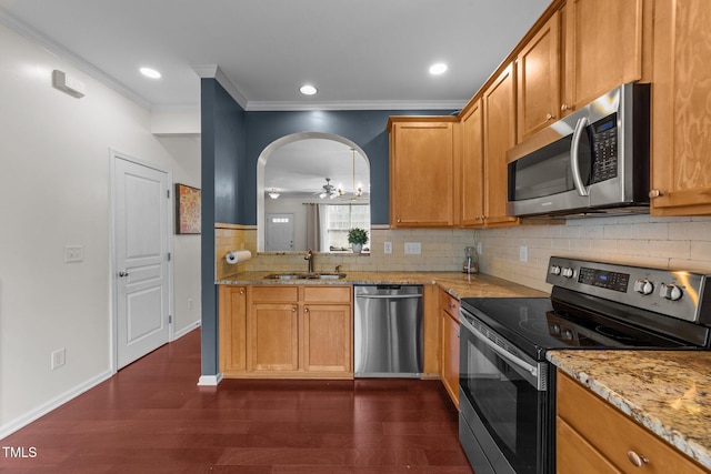 kitchen featuring a sink, dark wood-type flooring, tasteful backsplash, and stainless steel appliances