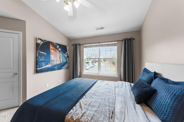 bedroom featuring visible vents, lofted ceiling, and a ceiling fan