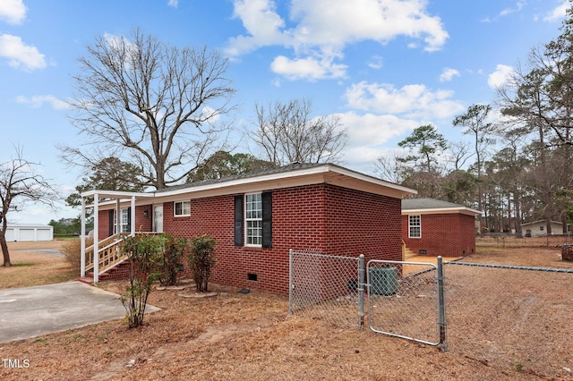 205 Woodside Dr, Goldsboro, NC 27534 - view of property exterior with brick siding, crawl space, a gate, and fence