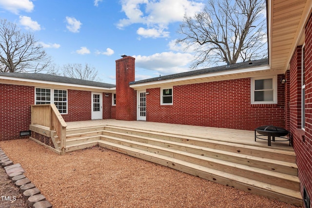 205 Woodside Dr, Goldsboro, NC 27534 - rear view of house featuring brick siding, a chimney, and a wooden deck