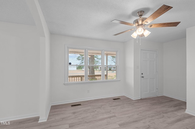 205 Woodside Dr, Goldsboro, NC 27534 - unfurnished room featuring baseboards, light wood-style floors, visible vents, and a textured ceiling