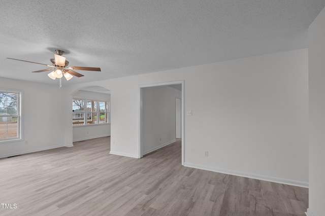 205 Woodside Dr, Goldsboro, NC 27534 - spare room featuring light wood-type flooring, plenty of natural light, baseboards, and ceiling fan