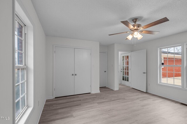 205 Woodside Dr, Goldsboro, NC 27534 - unfurnished bedroom with baseboards, a textured ceiling, and light wood-style flooring