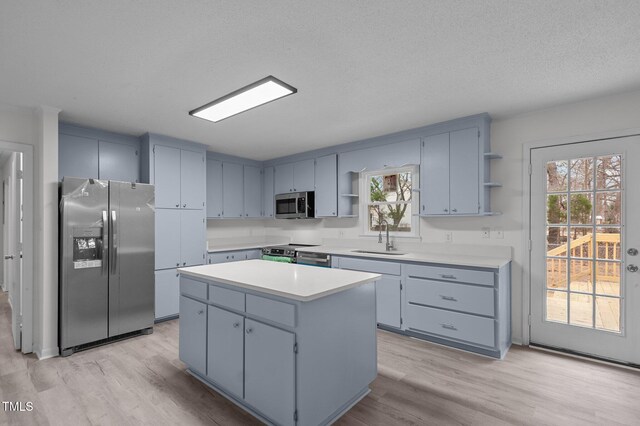 205 Woodside Dr, Goldsboro, NC 27534 - kitchen with open shelves, a sink, light countertops, appliances with stainless steel finishes, and a center island