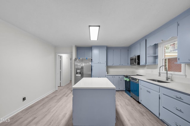 205 Woodside Dr, Goldsboro, NC 27534 - kitchen featuring a kitchen island, stainless steel appliances, light wood-type flooring, and a sink