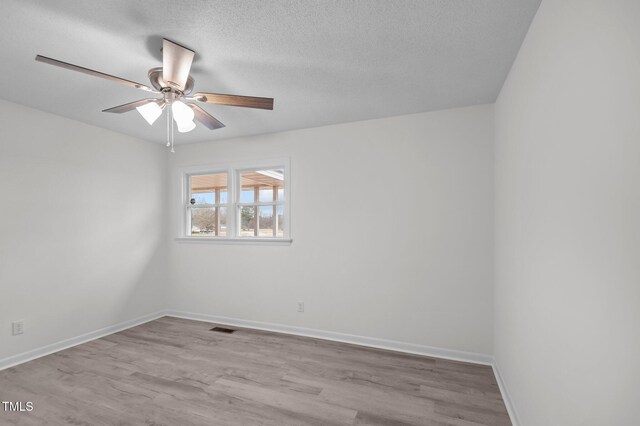 205 Woodside Dr, Goldsboro, NC 27534 - unfurnished room featuring visible vents, a textured ceiling, baseboards, and wood finished floors