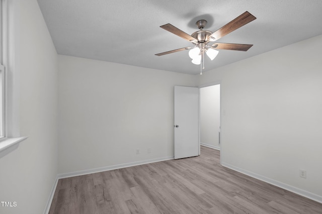 205 Woodside Dr, Goldsboro, NC 27534 - spare room featuring a textured ceiling, baseboards, ceiling fan, and wood finished floors