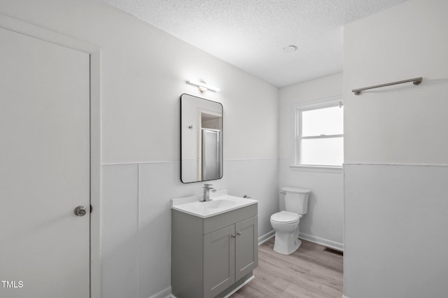 205 Woodside Dr, Goldsboro, NC 27534 - bathroom with visible vents, toilet, a textured ceiling, wood finished floors, and vanity