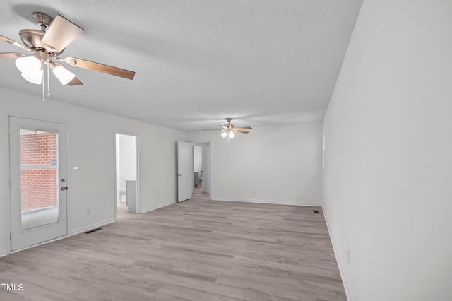 205 Woodside Dr, Goldsboro, NC 27534 - empty room featuring visible vents, baseboards, light wood-style floors, a textured ceiling, and a ceiling fan
