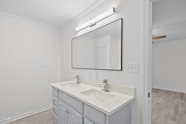 205 Woodside Dr, Goldsboro, NC 27534 - bathroom featuring double vanity, wood finished floors, crown molding, and a sink