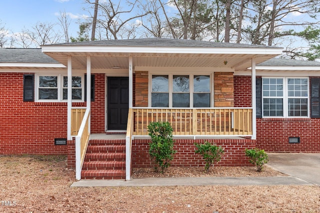 205 Woodside Dr, Goldsboro, NC 27534 - view of front of house featuring crawl space, covered porch, brick siding, and roof with shingles